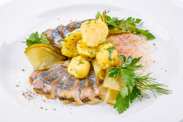 istock Herring with potatoes and onion on a white plate macro close up 1393905260