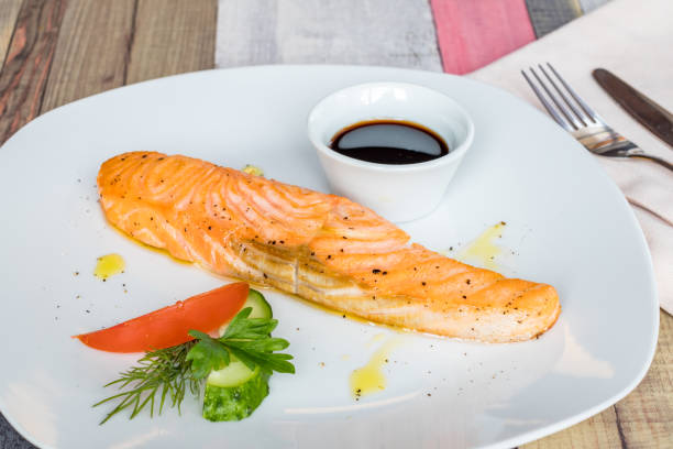 istock Salmon steak on the grill with narsharab on a white plate 1393905317