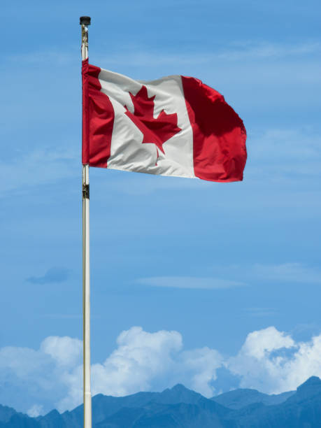 istock Canadian Flag Flying High on a Mountain Top 1393906953