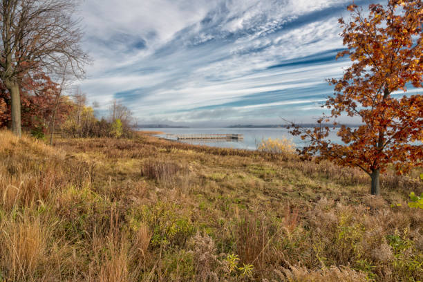 Fall Foliage and clouds reflecting on a Minnesota lake.