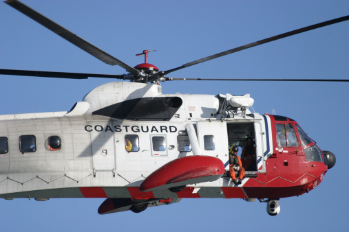 Miami, Florida, USA - May 17, 2022: US Coast Guard helicopter flying over Miami Beach.