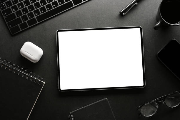 istock Modern black office desk background with office accessories and digital tablet mockup. 1393912449