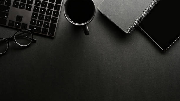Modern black office desk with office supplies and copy space