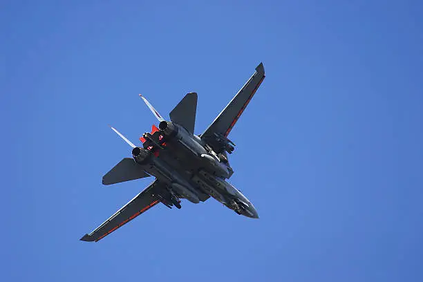F-14 Tomcat in turn flying against blue sky