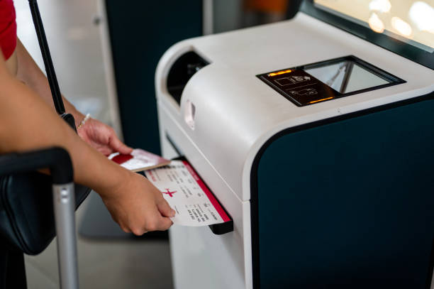istock Businesswoman Using Automated Check In Machine At Airport 1393914890