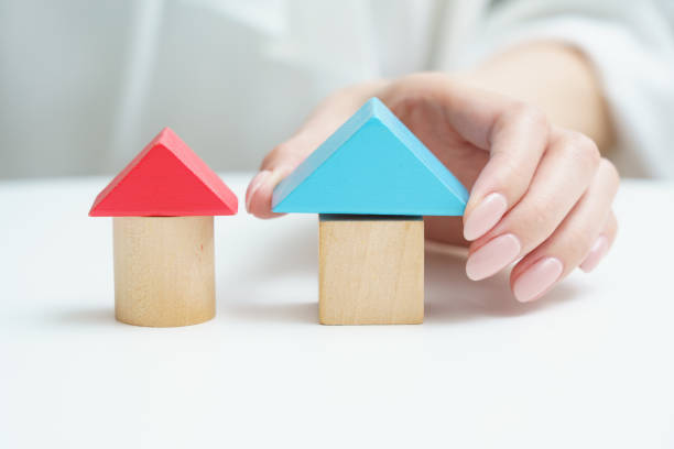 istock Hands touching building block house 1393917526