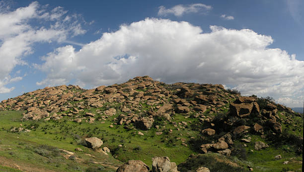 blue sky white clouds and rocks stock photo