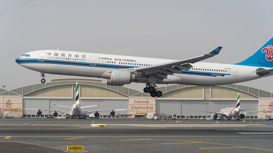 Dubai, United Arab Emirates. Landing of an Airbus A330-300 at Dubai International airport China Southern airline carrier. Close up view of the airplane