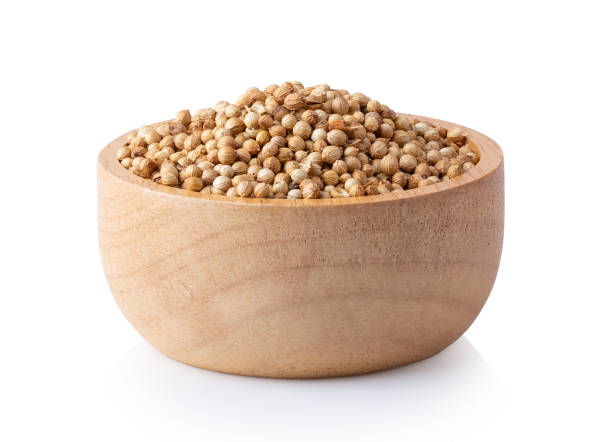 istock coriander seeds in wood bowl isolated on white 1393931492