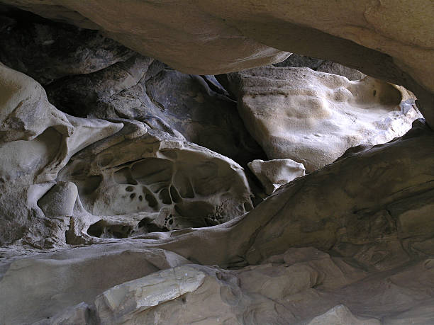 rock cave illuminated by sun stock photo