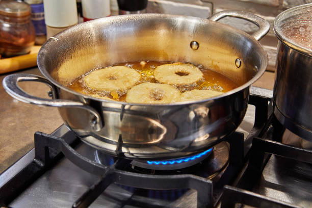 istock Cooking apple pancake. Apple donut in boiling oil 1393934455