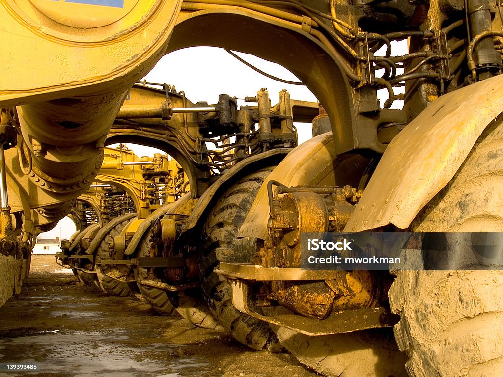 underbelly of earthmovers Five earthmovers lined up in a row Machinery Stock Photo