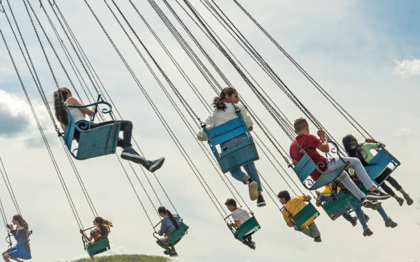 kids have fun in a chain carousel. - carnival amusement park amusement park ride traditional festival imagens e fotografias de stock