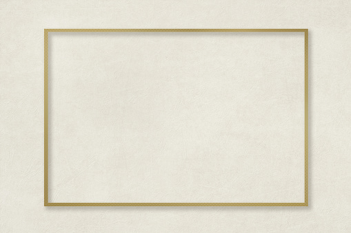 A golden frame on an elegant beige background with a matte texture