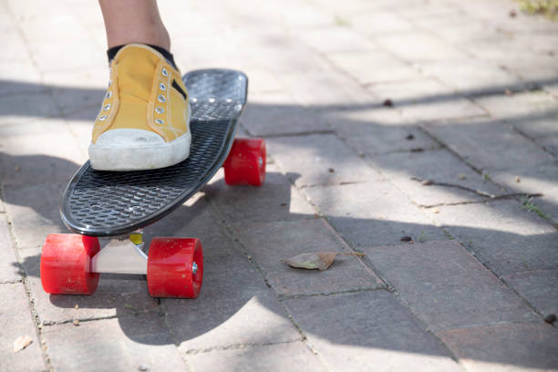 istock The feet of a woman practicing skateboarding on a bumpy road 1393938639