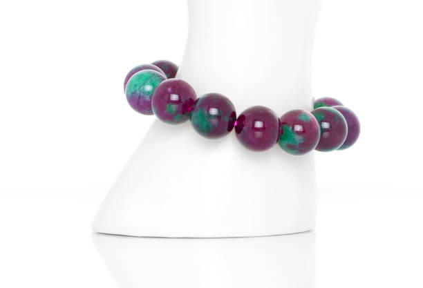 Child hand is wearing a loom braclet on her wrist .