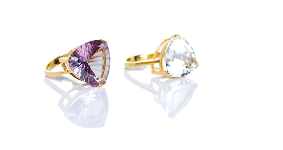 Amethyst and white Topaz Jewel or gems ring on white background with reflection. Collection of natural gemstones accessories. Studio shot