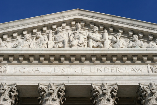 close up of the engraving above entrence the supreme court.