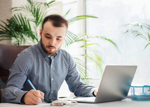 istock Businessman working on his laptop in an office 1393940151