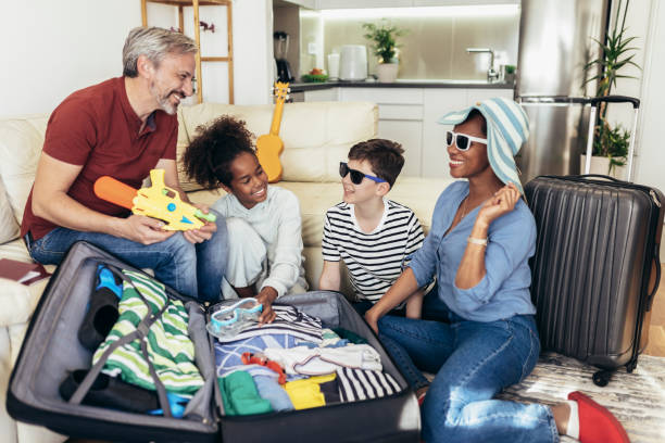 istock Happy family  packing for summer holidays 1393943580