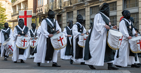 Holy Week Valladolid 2022, brothers with drums of the brotherhood of our risen Lord Jesus during the Good Friday procession through a central street of the city