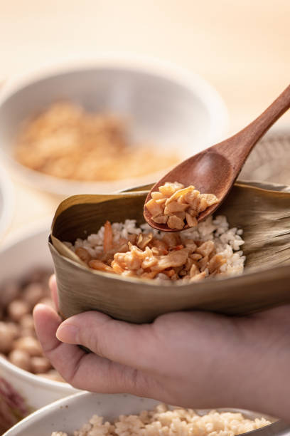 istock Making zongzi food - preparing and wrapping Chinese rice dumpling. 1393945578