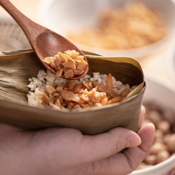 istock Making zongzi food - preparing and wrapping Chinese rice dumpling. 1393945794