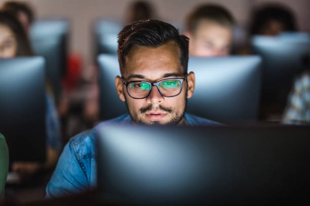 estudante do sexo masculino aprendendo uma palestra sobre pc desktop no laboratório de informática. - computer lab computer people computer monitor - fotografias e filmes do acervo