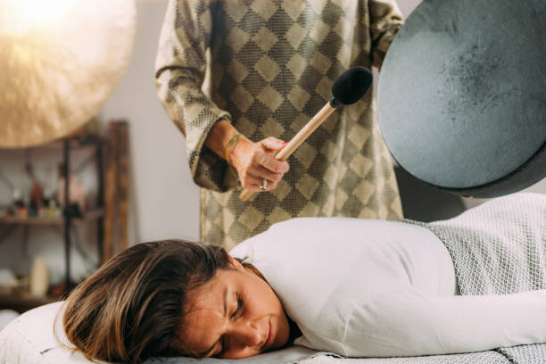 Playing Moon Drum in Sound Healing Therapy Session