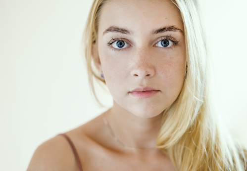 Closeup portrait of beautiful sensual woman with blue eyes.