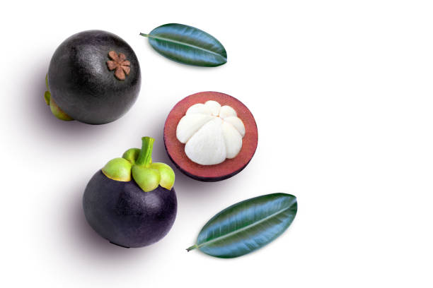 istock Mangosteen fruit with cut in half sliced and green leaf isolated on white background. 1393950857