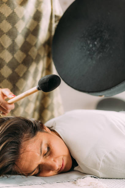 istock Playing Moon Drum in Sound Healing Therapy Session 1393951670