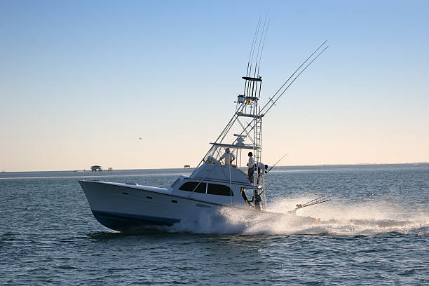 Multi-Level fishing boat on the water with fishing poles Fishing boat off the coast of Florida fishing boat photos stock pictures, royalty-free photos & images