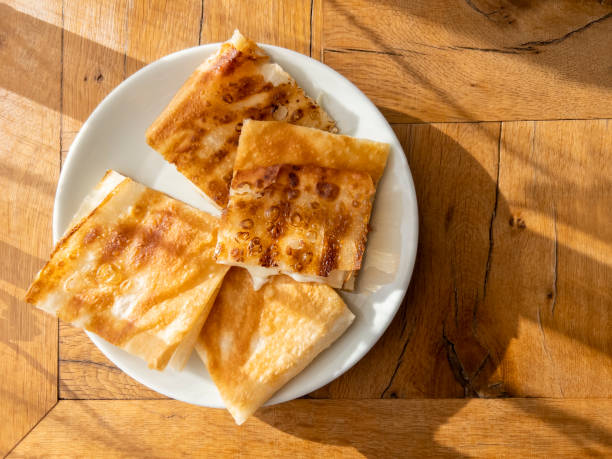 turkish cheese pie on wooden table, top view - börek turkish culture middle eastern cuisine pie imagens e fotografias de stock