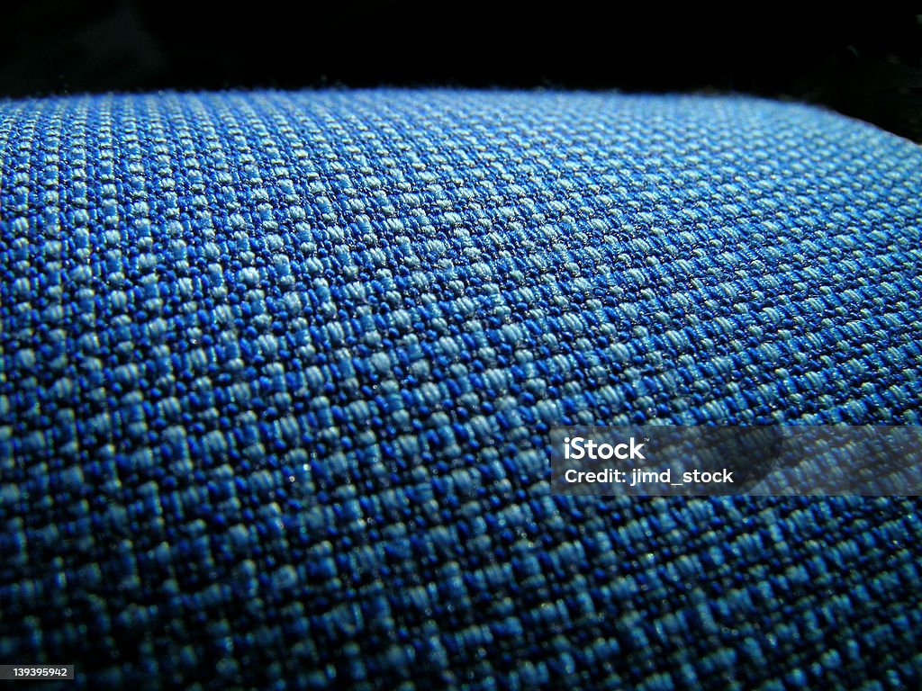 Blue Fabric Horizon Macro of blue weave in fabric slopes upward to a curved black horizon line. Above Stock Photo