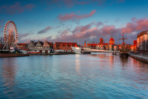 Beautiful architecture of Gdansk old town reflected in the Motlawa river at sunrise, Poland