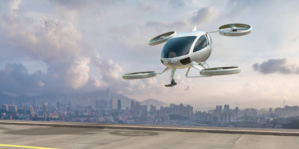 eVTOL Electric Vertical Take Off and Landing Aircraft About To Land Near City A generic white electric powered Vertical Take Off and Landing eVTOL aircraft with four rotors, coming in to land on roof top helipad with high city city buildings in the background. The sky is bright with clouds and it's late afternoon / early morning. Taxi stock pictures, royalty-free photos & images