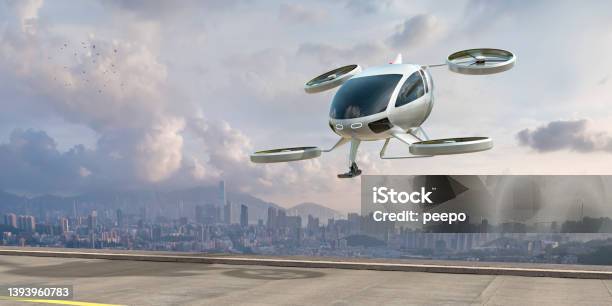 Evtol Electric Vertical Take Off And Landing Aircraft About To Land Near City Stock Photo - Download Image Now