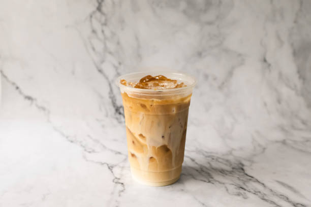 istock Iced latte coffee on plastic cup place marble background 1393962903