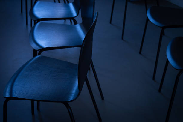 istock A row of chairs in darkness 1393964426