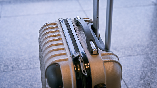 Close-up of brown plastic suitcase. Business travel holidays concept