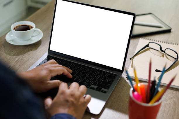istock mockup blank screen computer man using laptop  on desk in office laptop with blank copy space screen for your advertising text message 1393964909