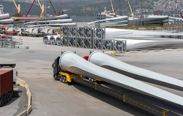 wind turbine blades waiting to be transported at the port