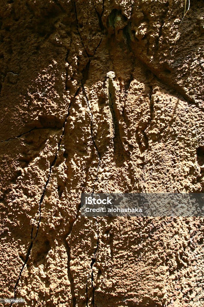 Texture of sand hill. Vertical shot of the side of a sand hill. Very rough and full of texture, with cracks and bumps Bumpy Stock Photo