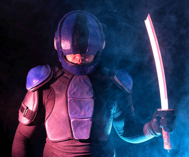 istock Cyberpunk future concept. Bionic cyborg police officer with short samurai sword stands in dark with smoke, fume. Halfman robot looks at camera. Futuristic science fiction scene. 1393967431