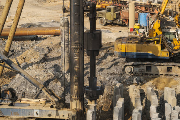 istock The pile driver hammers the pile. 1393970215