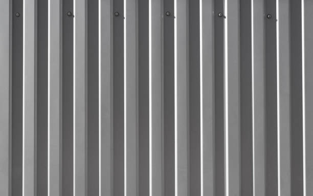 istock Iron construction gray profiled sheet screwed to wall. Facing or roofing building material. Textured uneven steel background, copy space for your text 1393970269