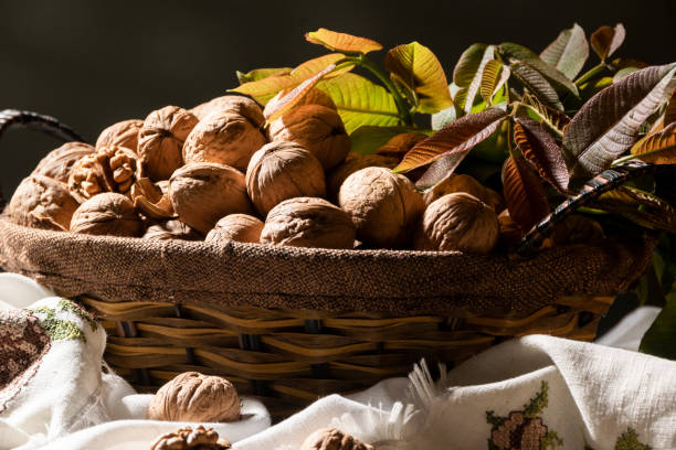 istock Whole walnuts in basket, food harvest, rustic style 1393970824