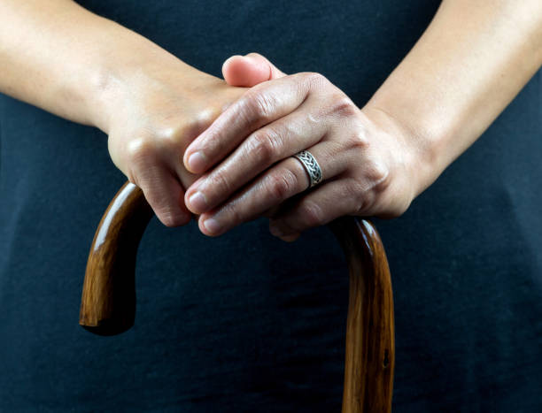 istock Elderly Lady Holding Walking Stick with Both Hands 1393971740