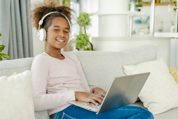 istock Little girl using laptop at home 1393974696